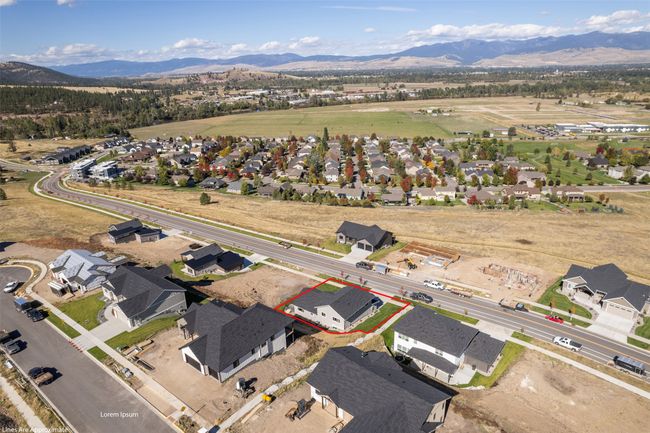 Aerial overview of property's location with property parcel outlined, mountains, and nearby suburban area | Image 52