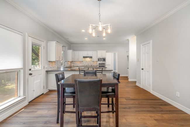 Breakfast room with chandelier looking into kitchen | Image 7
