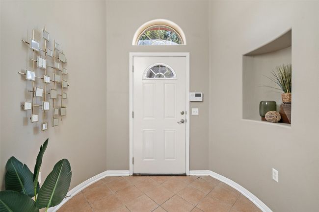 Foyer entrance with light tile patterned floors and baseboards | Image 8