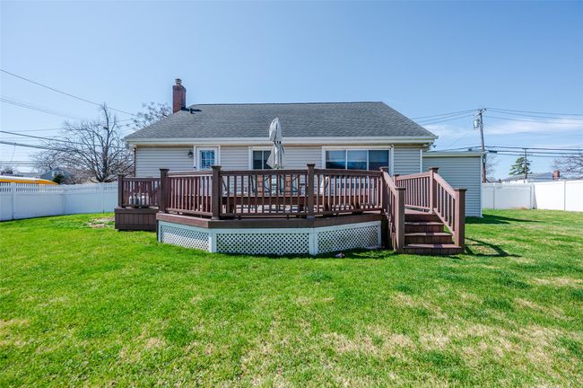 Back of house featuring roof with shingles, fence, and a chimney | Image 21