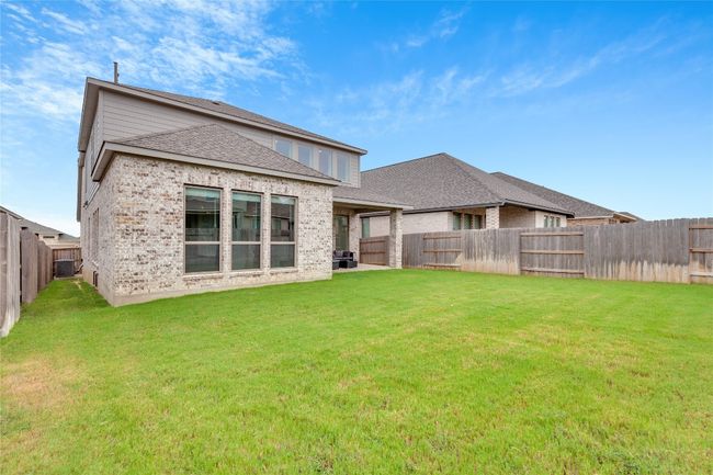 Back of house featuring roof with shingles, a fenced backyard, and brick siding | Image 40