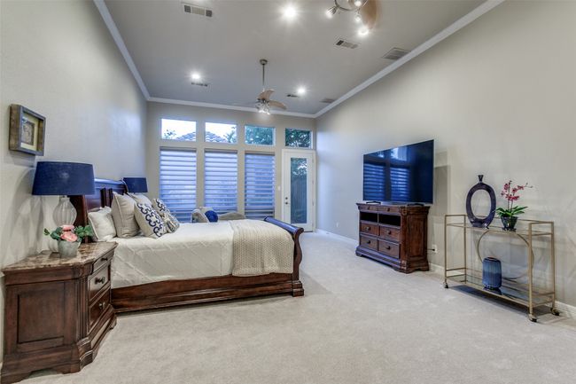 This massive bedroom, just beyond the family room, has it's own recently updated bathroom and makes for a fantastic second primary bedroom, or is also a great flex space for a downstairs recreation or workout room. The possibilities for this space are endless! | Image 21