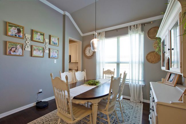 Dining room featuring baseboards, dark wood-style flooring, crown molding, and vaulted ceiling | Image 7