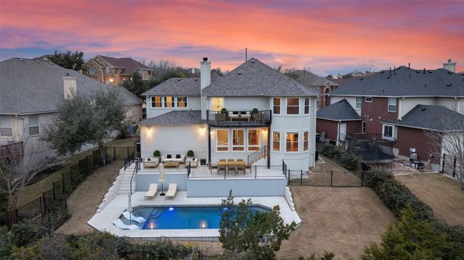 Back of property with a patio, stucco siding, a chimney, a residential view, and a fenced backyard | Image 38