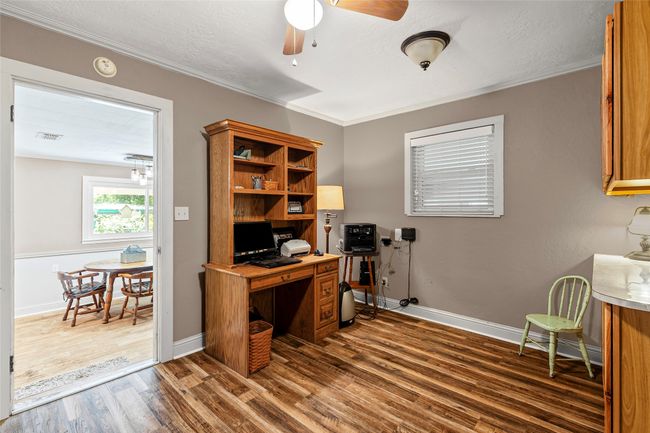 Office space featuring wood finished floors, ceiling fan, crown molding, and a textured ceiling | Image 9