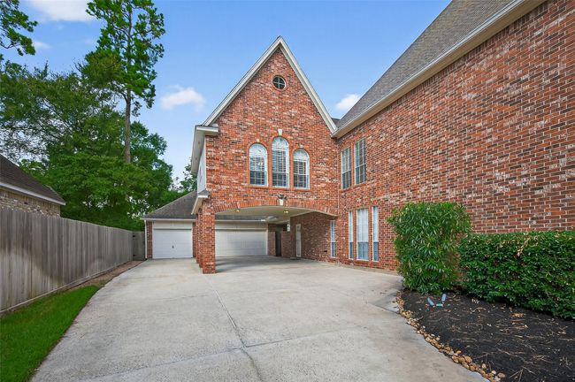 Long drive with carport leading to the full size 3-garage, with plenty of parking. | Image 40