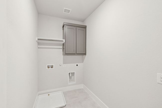 Laundry area featuring electric dryer hookup, hookup for an electric dryer, cabinet space, and hookup for a washing machine | Image 23