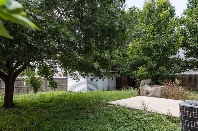 Fenced backyard featuring a storage shed and a patio | Image 24