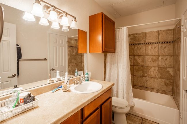 Full bath with vanity, shower / tub combo, and tile patterned floors | Image 8