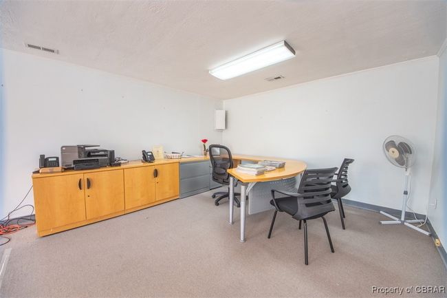Office area with ornamental molding and light carpet | Image 13