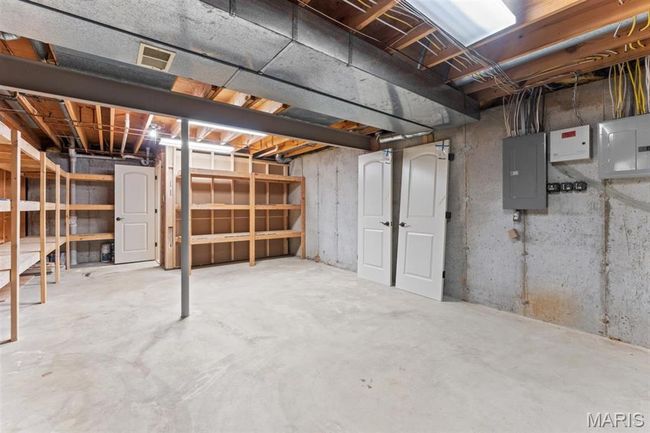 Unfinished basement featuring electric panel | Image 58
