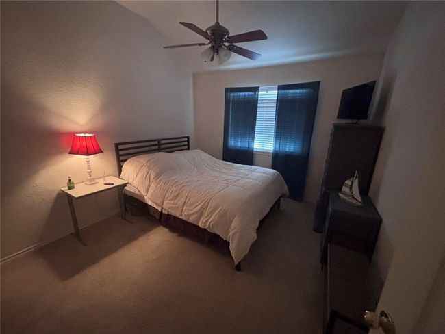 Carpeted bedroom featuring a ceiling fan | Image 13
