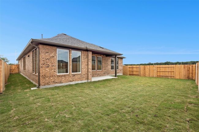 Back of house featuring brick siding and a shingled roof | Image 25