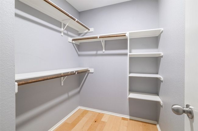 Walk in closet featuring wood floors and recessed lighting | Image 18