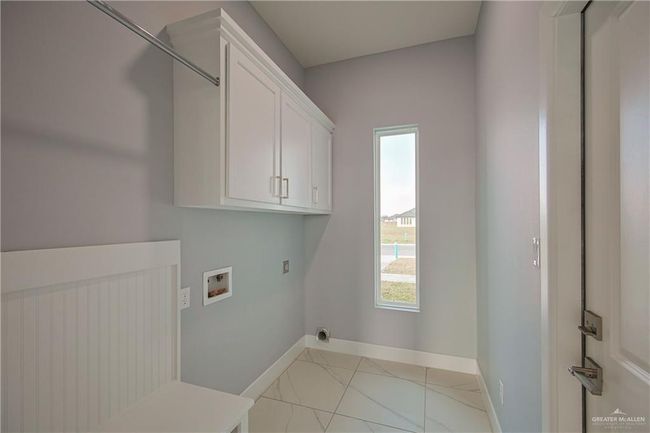 Washroom with cabinets, hookup for a washing machine, and hookup for an electric dryer | Image 19