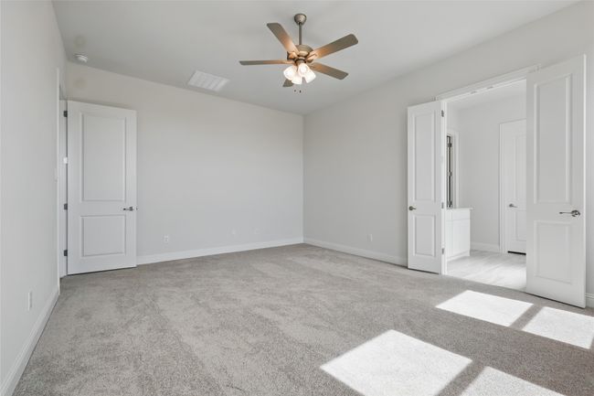 Unfurnished bedroom featuring visible vents, light carpet, baseboards, and ceiling fan | Image 17