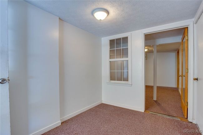 Carpeted empty room with a textured ceiling | Image 30