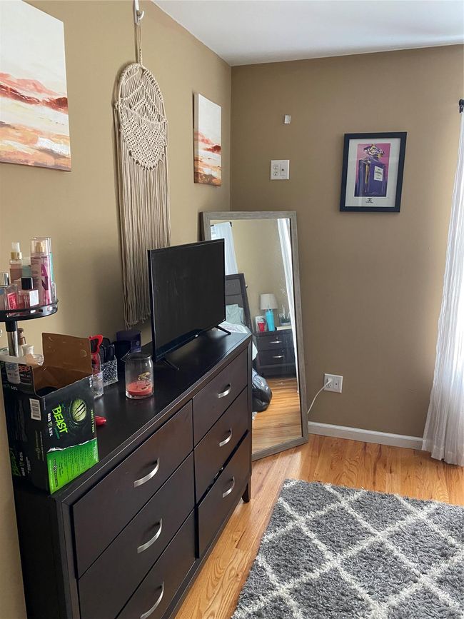 Bedroom featuring baseboards and light wood-type flooring | Image 10