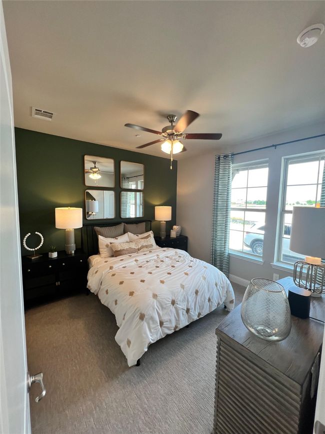 Carpeted bedroom with multiple windows and ceiling fan | Image 12