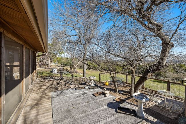 Wooden deck featuring a patio area and a yard | Image 28
