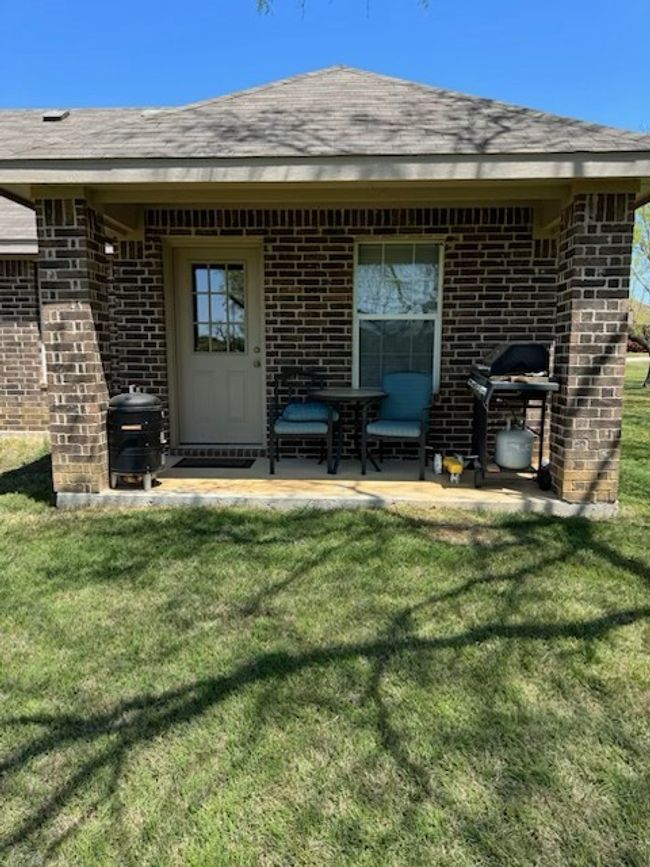 Back of property with brick siding, a shingled roof, a patio, and a lawn | Image 20