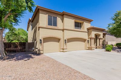 Rv gate off the 3 car garage & drive leads into large side yard with parking or shed access. Curbless driveway is sport and Tesla friendly. | Image 2