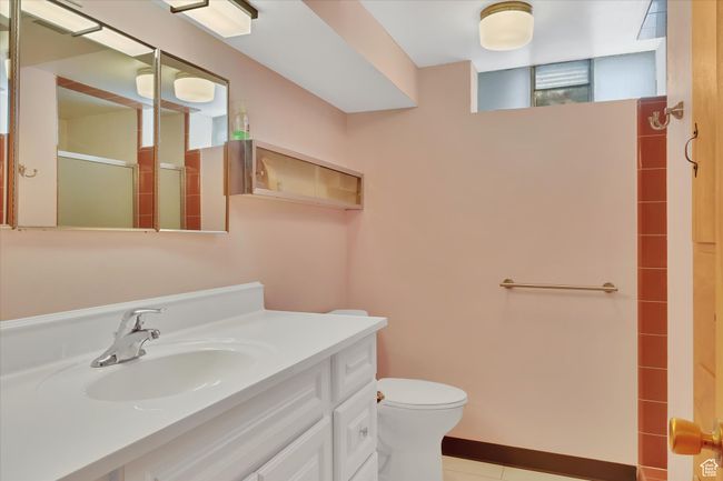 Bathroom featuring an enclosed shower, vanity, and tile patterned flooring | Image 23