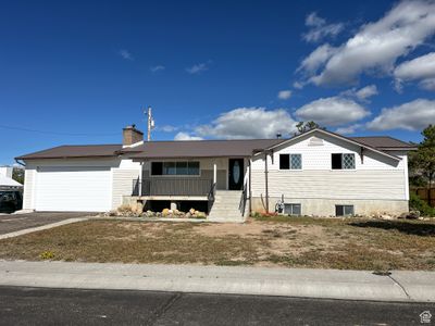 View of front facade with a garage and covered porch | Image 1