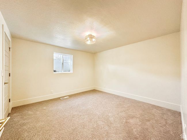 Unfurnished room with carpet flooring and a textured ceiling | Image 38