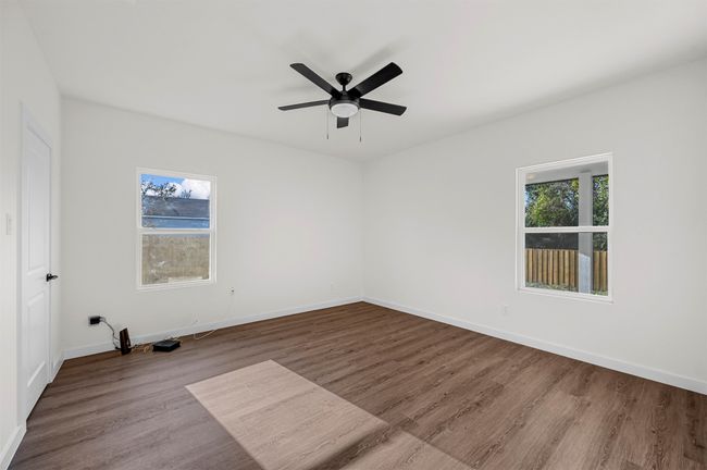 Unfurnished room with wood finished floors, plenty of natural light, and baseboards | Image 16