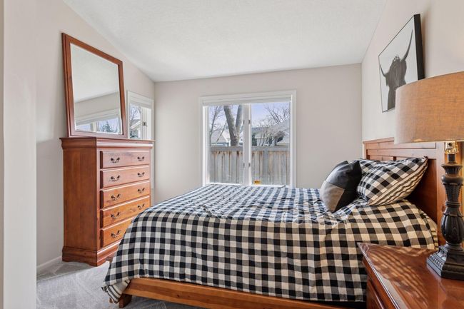 The second bedroom on the main level also features new carpet and paint | Image 13