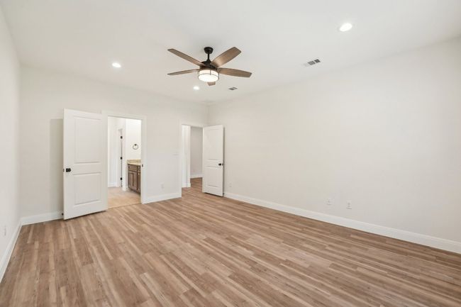 Primary bedroom featuring recessed lighting, baseboards, visible vents, and Vinyl Wood Plank floor | Image 21