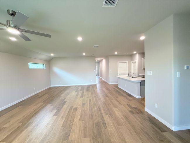 Unfurnished living room featuring a ceiling fan, a sink, light wood-style floors, recessed lighting, and​​‌​​​​‌​​‌‌​‌‌​​​‌‌​​‌‌​‌​​​​​‌ baseboards | Image 10