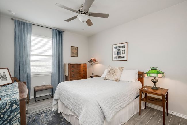 Bedroom with wood tiled floor, ceiling fan, and baseboards | Image 22