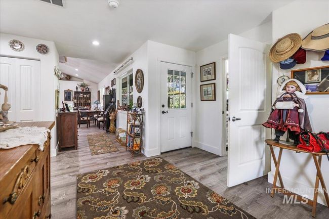 Front entry, showing door to utility room and back door. | Image 8