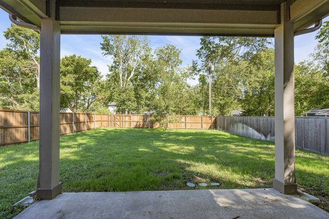 View of yard featuring a fenced backyard and a patio area | Image 23