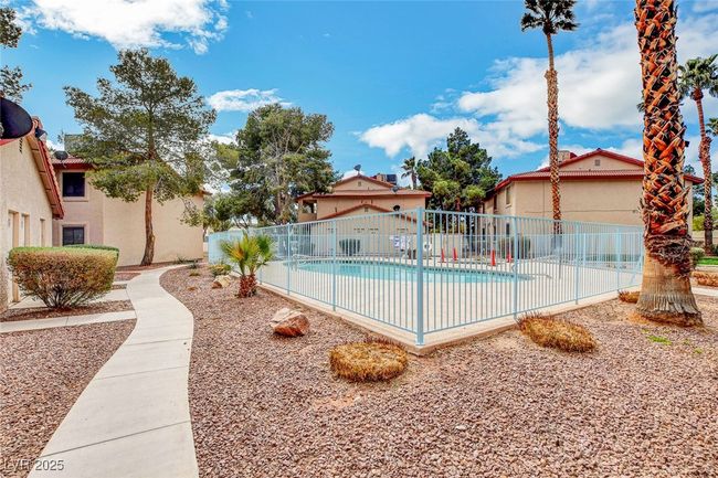 Community pool featuring fence | Image 36