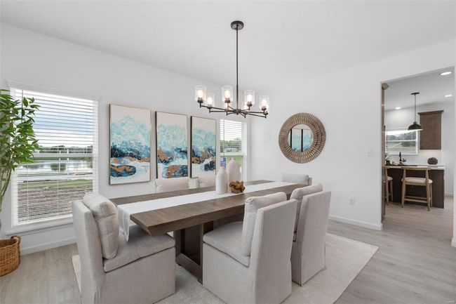 Dining room featuring light hardwood / wood-style flooring and a notable chandelier | Image 16