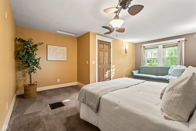 carpeted bedroom featuring a ceiling fan and baseboards | Image 34