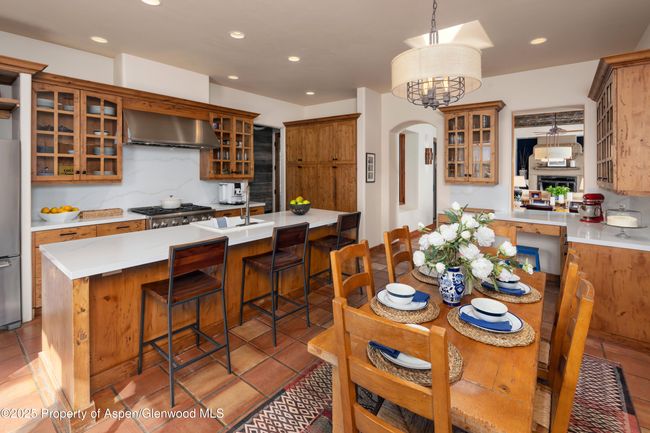 With magnificent morning and evening light, plenty of seating and a breakfast bar, this kitchen is the heart to this home. | Image 13