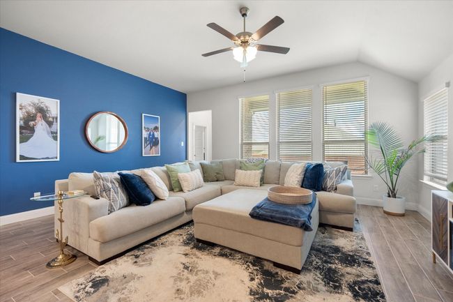 Living area featuring wood finished floors, a ceiling fan, and lofted ceiling | Image 13