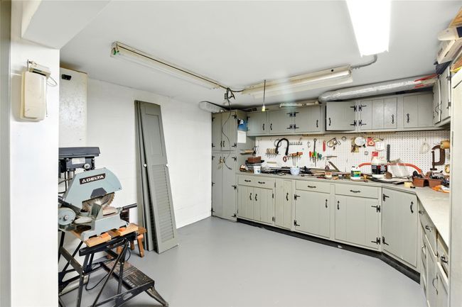 Kitchen with concrete flooring and light countertops | Image 40