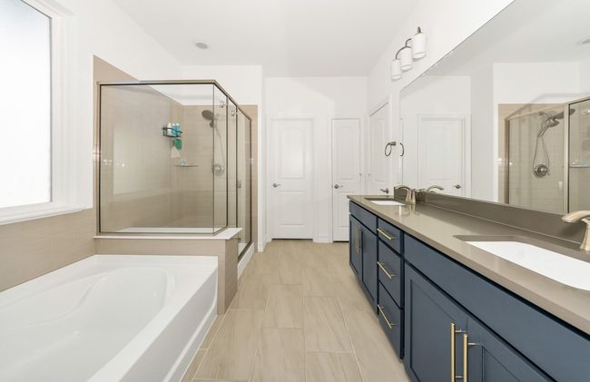 Full bathroom featuring a shower stall, a garden tub, a sink, and double vanity | Image 15