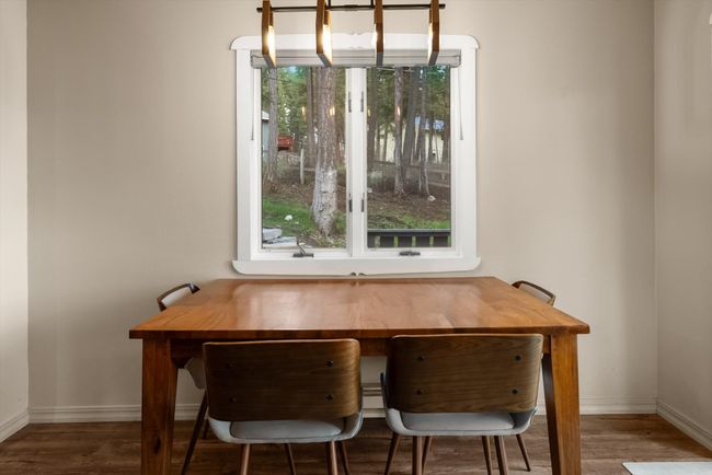 Dining area with healthy amount of natural light, wood finished floors, and baseboards | Image 16