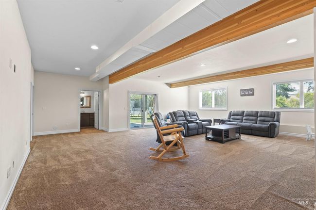 Living room featuring carpet floors, healthy amount of natural light, beam ceiling, and recessed lighting | Image 23