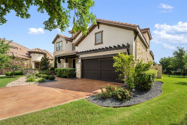 Mediterranean / spanish home featuring stone siding, a tile roof, driveway, and stucco siding | Image 4
