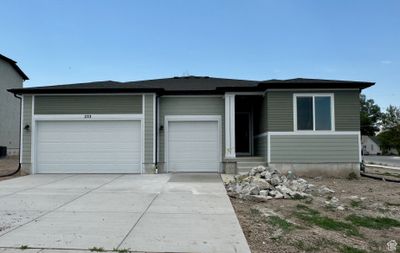 View of front of property featuring a garage and central AC | Image 1