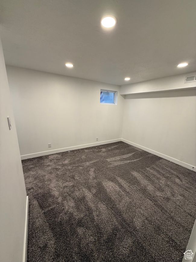 Below grade area with dark carpet, visible vents, and recessed lighting | Image 14
