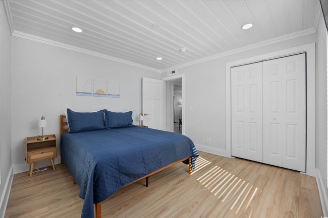 Bedroom featuring recessed lighting, crown molding, light wood-style flooring, baseboards, and a closet | Image 31