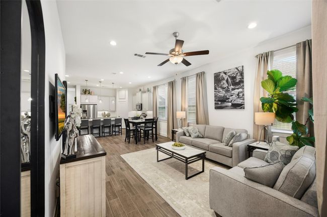 This open living space seamlessly flows into the kitchen and dining areas, offering plenty of room for gatherings and everyday comfort in a setting that feels both elegant and relaxed. | Image 16